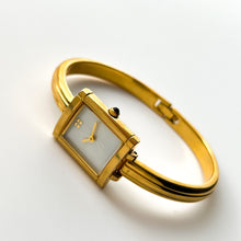 Load image into Gallery viewer, Vintage 90s Yves Saint Laurent Ladies' Bangle Style Quartz Watch with Gold-Tone Bracelet and White Mother of Pearl Dial