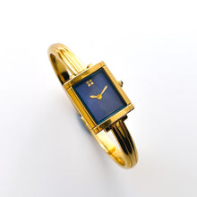 Load image into Gallery viewer, Vintage 90s Yves Saint Laurent Ladies' Bangle Style Quartz Watch with Gold-Tone Bracelet and Metallic Blue Dial