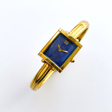 Load image into Gallery viewer, Vintage 90s Yves Saint Laurent Ladies' Bangle Style Quartz Watch with Gold-Tone Bracelet and Metallic Blue Dial