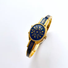 Load image into Gallery viewer, Vintage André Mouche Quartz Watch with Gold and Navy Enamel Floral Design, Concealead Dial and Gold-Plated Bangle Bracelet