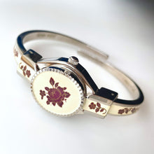 Load image into Gallery viewer, Vintage André Mouche Quartz Watch with Burgundy Enamel Floral Design, Concealed Dial and Silver-Tone Bangle Bracelet