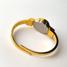 Load image into Gallery viewer, Vintage André Mouche Quartz Watch with Beige and Blue Enamel Floral Design, Concealed Dial and Gold-Plated Bangle Bracelet