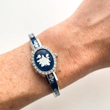 Load image into Gallery viewer, Vintage André Mouche Quartz Watch with Navy Enamel Floral Design, Concealed Dial and Silver-Tone Bangle Bracelet
