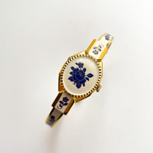 Load image into Gallery viewer, Vintage André Mouche Quartz Watch with Beige and Blue Enamel Floral Design, Concealed Dial and Gold-Plated Bangle Bracelet