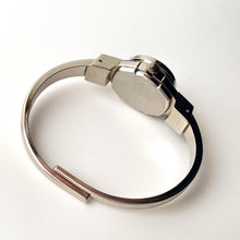 Load image into Gallery viewer, Vintage 1999 André Mouche Quartz Watch with Pink Enamel Floral Design, Concealed Dial and Silver-Tone Bangle Bracelet