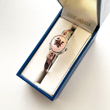 Load image into Gallery viewer, Vintage 1990s André Mouche Quartz Watch with Pink & Burgundy Enamel Floral Design, Concealed Dial and Silver-Tone Bangle Bracelet