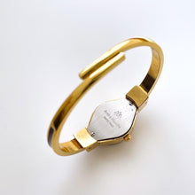 Load image into Gallery viewer, Vintage André Mouche Quartz Watch with Burgundy Enamel Floral Design, Concealead Dial and Gold-Plated Bangle Bracelet