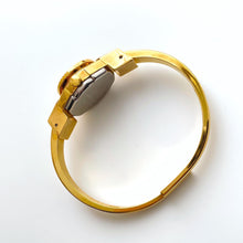 Load image into Gallery viewer, Vintage 1999 André Mouche Quartz Watch with Enamel Floral Design, Concealed Dial and Gold-Plated Bangle Bracelet