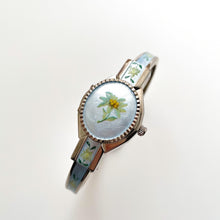 Load image into Gallery viewer, Vintage 1990s André Mouche Quartz Watch with Light Blue Enamel Floral Design, Concealed Dial and Silver-Tone Bangle Bracelet