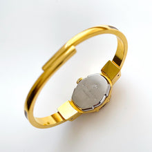 Load image into Gallery viewer, Vintage André Mouche Quartz Watch with Burgundy Enamel Floral Design, Concealead Dial and Gold-Plated Bangle Bracelet