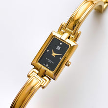 Load image into Gallery viewer, Givenchy Millésime – Gold-Plated Quartz Bangle Watch with Black Dial, 1990s