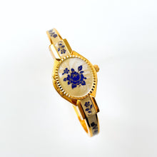 Load image into Gallery viewer, Vintage 00s André Mouche Quartz Watch with Beige and Blue Enamel Floral Design, Concealed Dial and Gold-Plated Bangle Bracelet - Boxed