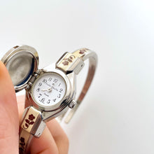 Load image into Gallery viewer, Vintage Andr√© Mouche Quartz Watch with Burgundy Enamel Floral Design, Concealed Dial and Silver-Tone Bangle Bracelet
