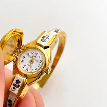 Load image into Gallery viewer, Vintage Andr√© Mouche Quartz Watch with Beige and Blue Enamel Floral Design, Concealed Dial and Gold-Plated Bangle Bracelet
