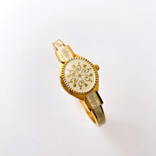 Load image into Gallery viewer, Vintage Andr√© Mouche Quartz Watch with Enamel Floral Design, Concealed Dial and Gold-Plated Bangle Bracelet
