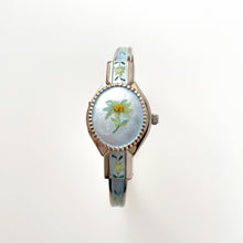 Load image into Gallery viewer, Vintage 1990s Andr√© Mouche Quartz Watch with Light Blue Enamel Floral Design, Concealed Dial and Silver-Tone Bangle Bracelet
