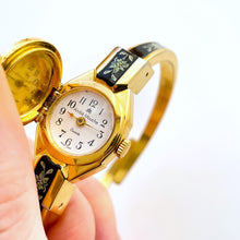 Load image into Gallery viewer, Vintage Andr√© Mouche Quartz Watch with Black and Green Enamel Floral Design, Concealed Dial and Gold-Plated Bangle Bracelet
