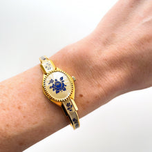 Load image into Gallery viewer, Vintage 00s Andr√© Mouche Quartz Watch with Beige and Blue Enamel Floral Design, Concealed Dial and Gold-Plated Bangle Bracelet - Boxed
