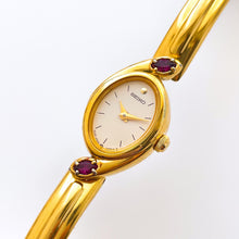 Load image into Gallery viewer, Very Rare 1990s Gold-Plated Seiko Articulated Bangle Quartz Watch with White Dial and Two Rubies

