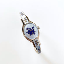 Load image into Gallery viewer, Vintage 1990s André Mouche Quartz Watch with Blue Enamel Floral Design, Concealed Dial and Silver-Tone Bangle Bracelet - Boxed
