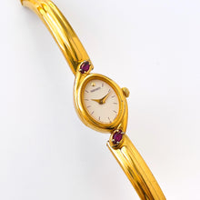 Load image into Gallery viewer, Very Rare 1990s Gold-Plated Seiko Articulated Bangle Quartz Watch with White Dial and Two Rubies
