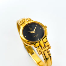 Load image into Gallery viewer, Vintage 1990s Gold-Plated Ladies&#39; Givenchy &#39;Millesime&#39; Bangle Watch with Black Dial and Quartz Movement
