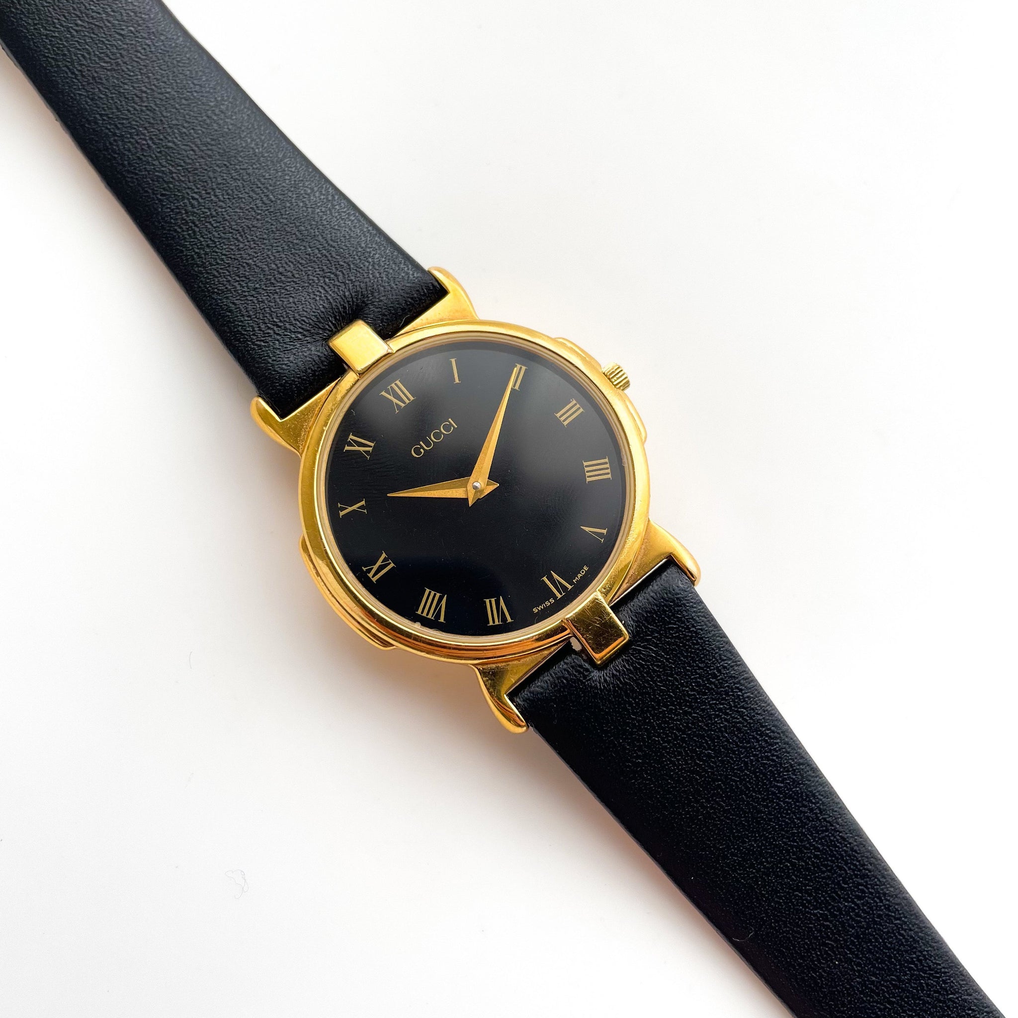 Gucci gold and black watch 2025